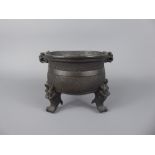 An Antique Chinese Bronze Censer, tripod base with incised motif decoration, mask handles with