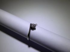 An 18ct White Gold Diamond Solitaire Cross Over Ring, approx 25 pt dia, size L, approx 1.8 gms.