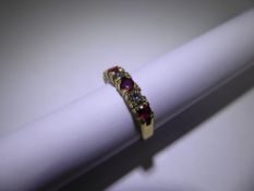 An 18 ct Yellow Gold, Diamond and Ruby Ring, approx 18 pts of dias, 4 x 2.75mm rubies, size L,