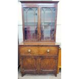 An Antique Mahogany Bureau Book Case, double cupboards beneath a fall-front pull out appointed desk,