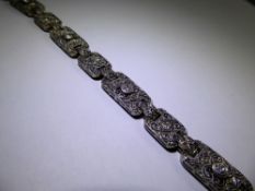 An Art Deco 18ct White Gold Diamond Cocktail Bracelet, the bracelet fashioned with twelve floral