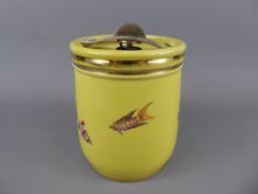 A Royal Doulton Biscuit Barrel with metal handle and pressurised lid depicting fishes on a yellow