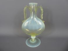 An Antique Vaseline Bottle Vase with decorative handles, approx 18 cms.