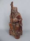 An Antique Hand Carved Chinese Holy Man, glass eyes, character marks to base, approx 15 cms.