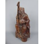 An Antique Hand Carved Chinese Holy Man, glass eyes, character marks to base, approx 15 cms.