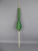 An Antique Ivory Handled Parasol, of green moire silk, approx 85 cms, the handle and finial carved