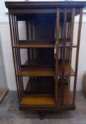 An Edwardian Oak Revolving Bookcase, with slatted compartments, approx 60 x 60 x 115 cms.