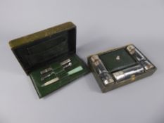 A Boxed Green Vanity Set, five miniature cut-glass bottles with silver hallmarked covers and a