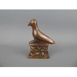 A Copper Opium Weight in the form of an Egyptian phoenix bird.