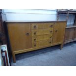 A Mid-20th Century Oak Gordon Russell Cotswold School Sideboard, four central drawers flanked by two