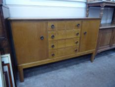 A Mid-20th Century Oak Gordon Russell Cotswold School Sideboard, four central drawers flanked by two