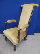 An English Victorian Prayer Chair with a carved walnut barley-twist frame and two arms, covered in