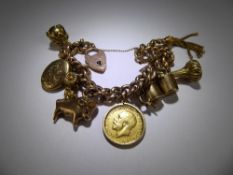 A Lady's 9 ct Yellow Gold Charm Bracelet, approx ten un-hallmarked charms with four 9 ct gold