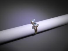 A 14ct Yellow Gold Blue Topaz and Diamond Bow-tie Ring. 1 x 1 pt 8 ct dia, 2 x 6 mm topaz, size L,