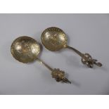 Two Continental Silver Sugar Spoons, the spoon bowls with embossed with rural domestic scenes. (2)