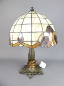 A Tiffany-Style Lamp with Art Nouveau-design coloured glass shade, approx 45 x 33 cms.