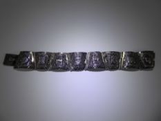 A Vintage Silver Peruvian Bracelet, the bracelet of eight hinged segments, depicting various