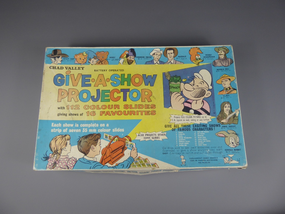 A Child's Vintage Chad Valley Battery Operated "Give-A-Show" Projector with 112 colour slides giving