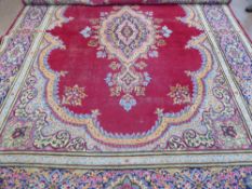 A Large 20th Century Persian Wool Carpet, ruby and pale blue, pink and purple ground of foliate