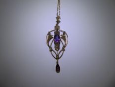 An Art Nouveau 9ct Yellow Gold Amethyst and Seed Pearl Pendant. The pendant suspended from a 9ct