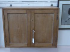 A Victorian Pine Wall Cupboard, with two panel doors, single interior shelf and lock and key, approx