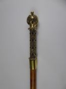 A Walking Cane with a highly decorative brass handle.