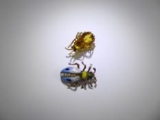 A Vintage Yellow Metal and Enamel Insect Brooch, together with a yellow stone spider brooch.