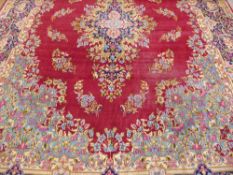 A Large 20th Century Persian Wool Carpet, ruby, pale blue and green ground of foliate design, approx