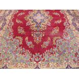 A Large 20th Century Persian Wool Carpet, ruby, pale blue and green ground of foliate design, approx