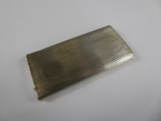 A Silver Metal Engine-Turned Cigarette Case and Match Strike, approx 9 x 4 cms.