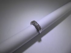 An 18ct White Gold Seven Stoned Diamond Ring, approx 1.26 ct dias, size N, approx 5.6 gms.