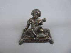 A Bronze Figurine, depicting a little girl seated on a pillow with her doll, approx 10 x 7 x 10