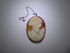 A 9ct Yellow Gold Mounted Shell Cameo, depicting a classical figure, wearing a miniature gold and