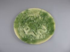A Green Jade-Effect Plate, the plate depicting chasing dragons in relief, approx 22 cms diameter.