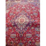 A Large 20th Century Persian Wool Carpet, jewel colours of geometric foliate design, approx 393 x