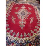 A Large 20th Century Persian Wool Carpet, primarily ruby and cobalt blue ground of foliate design,