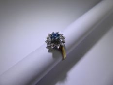 An 18ct Yellow and White Gold Diamond and Blue Zircon Ring. The ring designed as a flower, approx 10