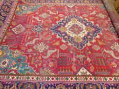 A Large 20th Century Persian Wool Carpet, ruby, jewel green, turquoise and cream ground of foliate