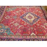 A Large 20th Century Persian Wool Carpet, ruby, jewel green, turquoise and cream ground of foliate