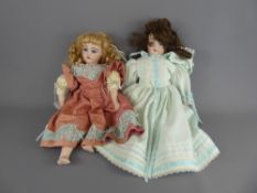 Two Lillian Miller Bisque-Headed Dolls, dressed in cotton dresses, together with a small quantity of