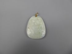 A White Jade Amulet Pendant on a 14ct yellow gold (tested) mount, carved with a fish and serpent,