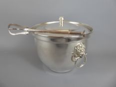 A Silver Plated Ice Bucket and Cover with lion mask handles, together with tongs. (2)