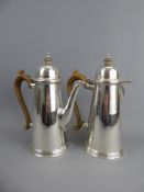 A Silver Coffee and Hot Water Pot, London hallmark, mm R.G., approx 1016 gms, with ebony handles and