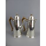 A Silver Coffee and Hot Water Pot, London hallmark, mm R.G., approx 1016 gms, with ebony handles and