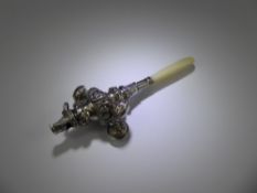 A Victorian Silver Rattle with mother of pearl handle.