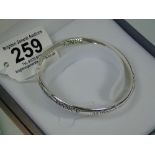 SILVER COLOURED, BOXED BANGLE, INSCRIBED 'DANCE AS THOUGH NO ONE IS WATCHING'