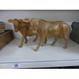 2 CARVED COW FIGURES