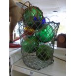 7 GLASS FLOATS IN WIRE BASKET