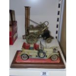 VINTAGE CAR IN DISPLAY CASE & MODEL OF STEPHENSON'S ROCKET