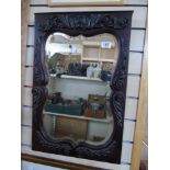 BEVELLED GLASS MIRROR WITH HEAVILY CARVED FRAME